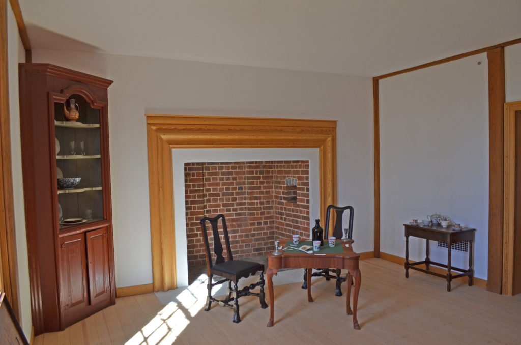 fireplace, small table and chairs inside Ferry Farm house