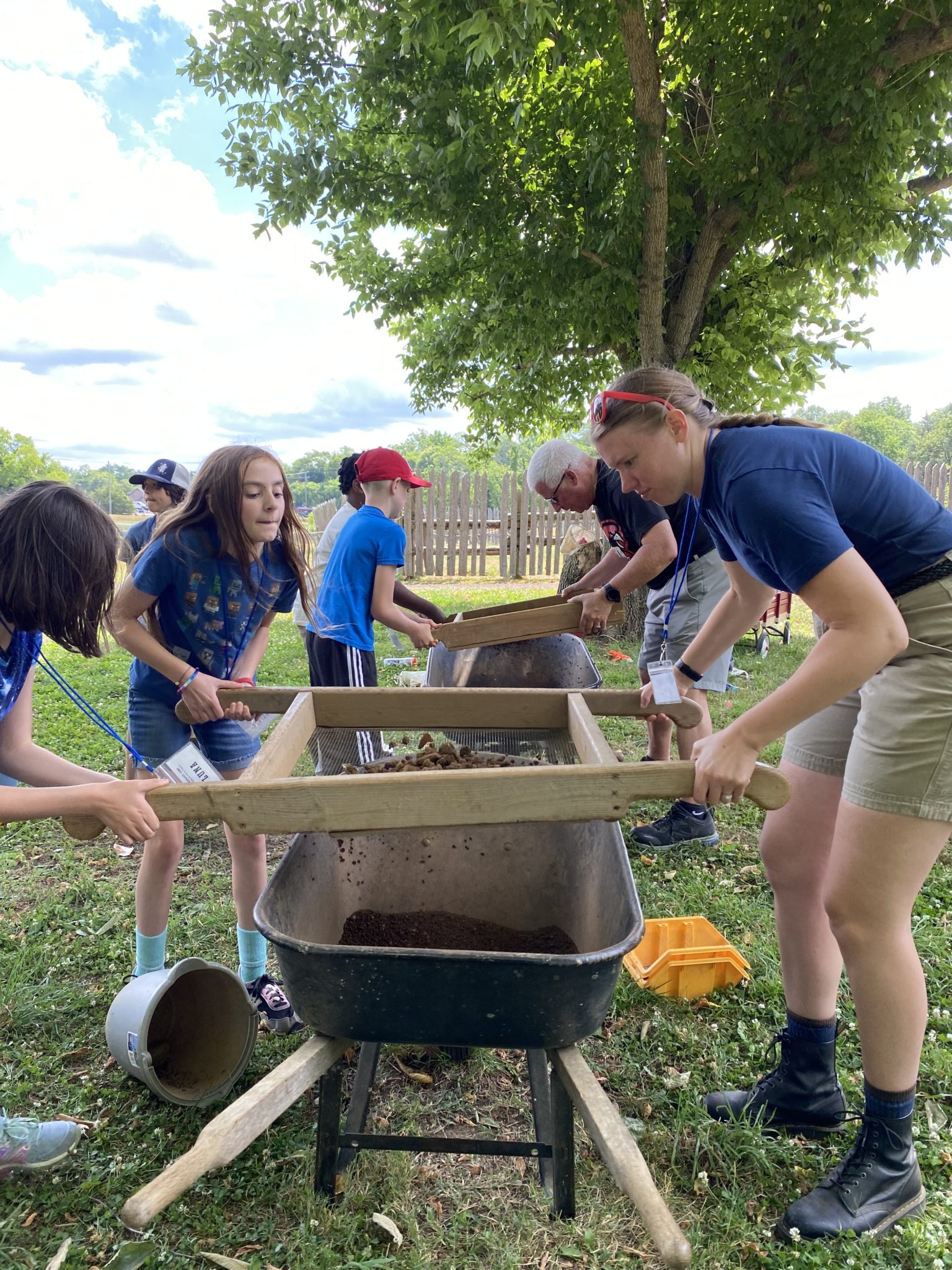 adults and children sifting dirt at archeological dig at Ferry Farm