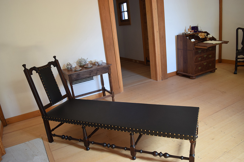 Chaise Lounge web fireplace, small table and chairs inside Ferry Farm house